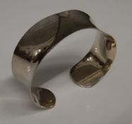 A silver cuff bangle (24.