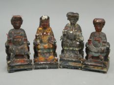 A set of four painted wooden figures