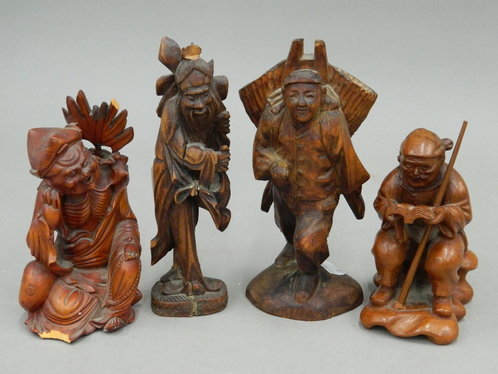 Four small carved wooden figures