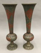 A pair of Indian enamel decorated metal vases
