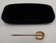 A 9 ct gold horseshoe stickpin