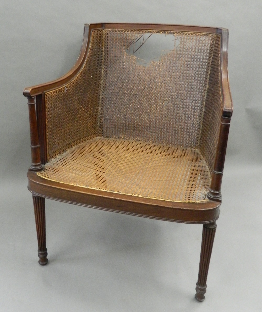 An early 20th century mahogany framed bergere chair