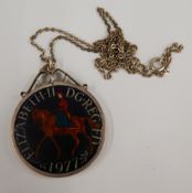 An enamelled silver coin pendant