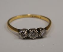 An 18 ct gold and platinum three stone diamond ring (1.