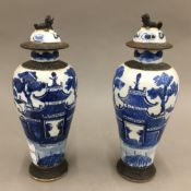 A pair of 19th century Chinese blue and white porcelain lidded vases. 27 cm high.