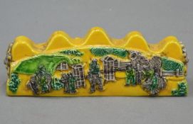 A Chinese yellow porcelain brush rest