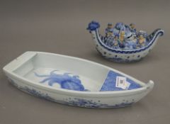 A Chinese pottery censer formed as a boat with figures and another pottery boat