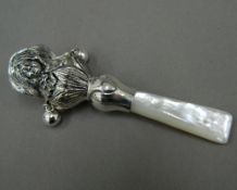 A silver and mother-of-pearl rattle
