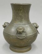 A bronze vase with ring handles