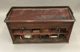 An early 20th century mahogany tambour fronted cabinet