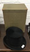 Two black top hats, one boxed. One 20.5 x 16 cm (55.5 cm inside circumference), possibly size 7.