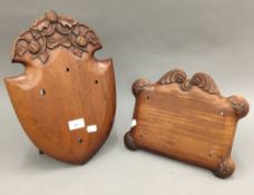 Two carved mahogany shields