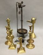 A quantity of antique candlesticks snuffers, whale oil lamps, etc.