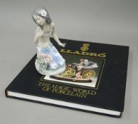 A Lladro porcelain figurine of a young girl and a Lladro book