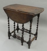 A small early 20th century oak barley twist gate leg table