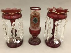 A pair of Victorian ruby glass lustres and a vase