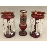 A pair of Victorian ruby glass lustres and a vase