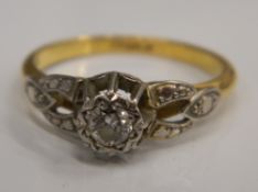 An 18 K gold diamond and solitaire ring (3.