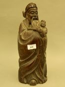 A Chinese carved hardwood model of a sage