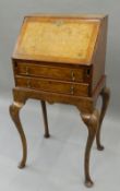 An early 20th century Queen Anne style walnut bureau