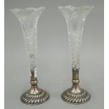 A pair of silver mounted cut glass bud vases