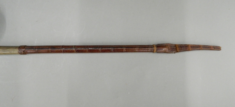 A late 19th/early 20th century crocodile skin mounted rhino horn riding crop Of typical form, - Image 3 of 6