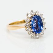 An 18 ct gold Ceylonese sapphire and diamond ring Of cluster form. 1.4 cm high.