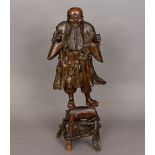 A 19th century Japanese root carving Formed as a bearded gentleman on a stand. 65 cm high.
