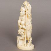 A late 19th century Japanese ivory okimono Modelled as a gentleman holding a brush and a gourd,