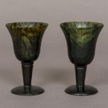 A pair of spinach jade goblets Each of diminutive size with flared bowl and domed foot.