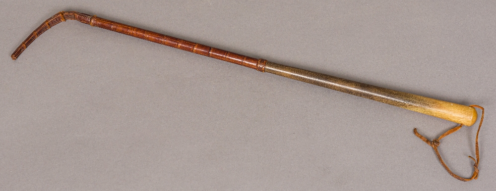 A late 19th/early 20th century crocodile skin mounted rhino horn riding crop Of typical form,