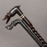 Two carved ebony walking sticks, possibly Ceylonese Each with animalier handle. The largest 96.