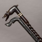 Two carved ebony walking sticks, possibly Ceylonese Each with animalier handle. The largest 96.