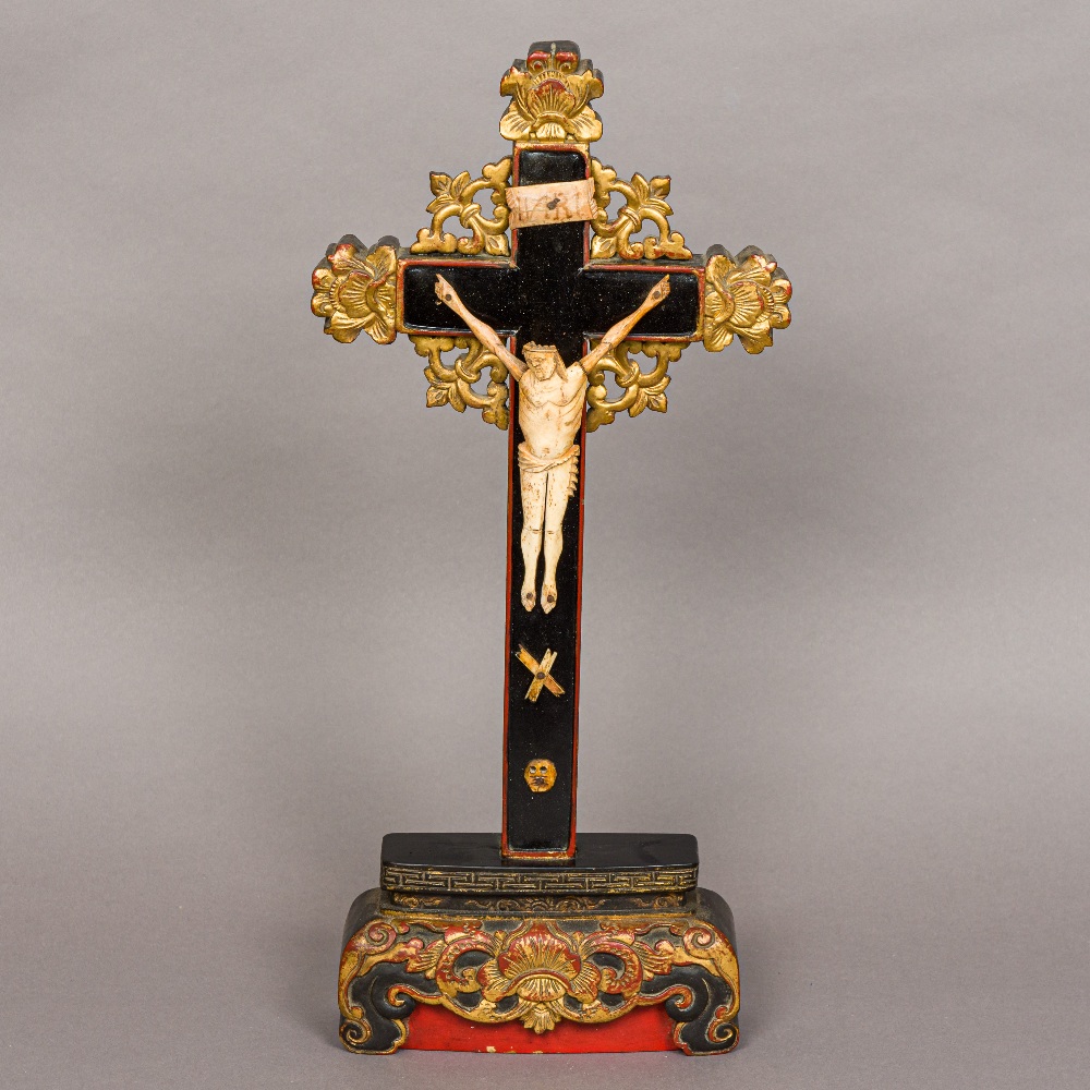 A 19th century Chinese painted naively carved bone crucifix Set with a bone Christ wearing a tied