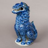 A Chinese porcelain dog-of-fo Modelled seated, with a blue glaze. 30 cm high.