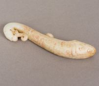 A Chinese carved pale jade belt hook Formed as a dragon. 15.5 cm high.