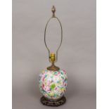 A Chinese porcelain vase Decorated in the round with floral blooms, now fitted as a lamp,