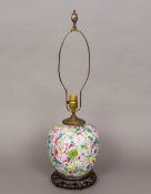 A Chinese porcelain vase Decorated in the round with floral blooms, now fitted as a lamp,