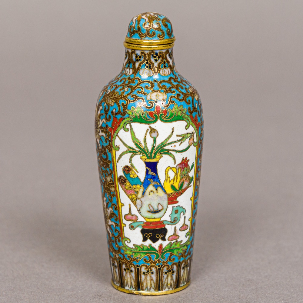 A fine quality Chinese cloisonne snuff bottle Decorated with opposing vignettes of flowering vases