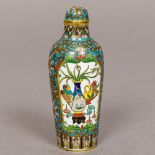 A fine quality Chinese cloisonne snuff bottle Decorated with opposing vignettes of flowering vases