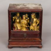 Four 19th century Chinese gilt heightened carved wooden figures Housed in a Chinese glazed hardwood