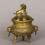 A 19th century Chinese bronze censer The removable pierced domed lid surmounted with a dog-of-fo,