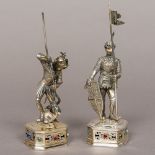 A pair of German sterling silver models of knights Each set with a carved face,