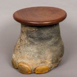 A preserved taxidermy elephant's foot Set as a wastepaper bin/stool with removable circular top.