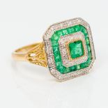 A 9 ct gold Art Deco style diamond and emerald ring Of domed canted square form. 1.4 cm wide.