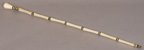 A 19th century whale bone walking stick Of segmented form, with carved knop handle. 89.5 cm long.