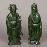 Two large Chinese carved spinach jade figures of sages One holding a ruyi sceptre,