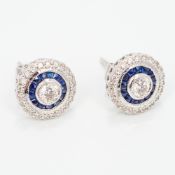 A pair of 18 ct white gold sapphire and diamond earrings Of target form. Each 8mm diameter.