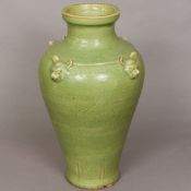 A large Chinese pottery vase Of tapering ovoid form, with all over celadon glaze,