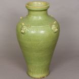 A large Chinese pottery vase Of tapering ovoid form, with all over celadon glaze,